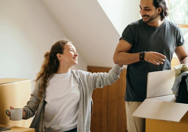 Couple unpacking boxes in a bright new home