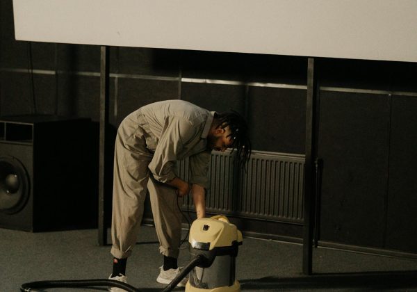 Worker using a vacuum cleaner in a commercial interior